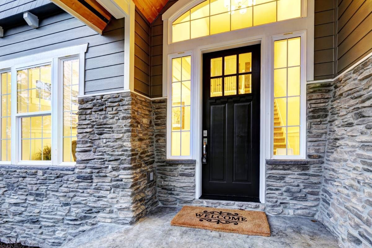 A residential home's exterior front door with sidelights that are lacking window blinds on them at Harmony Blinds & Shutters near San Diego, CA