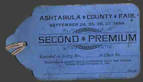A light blue Ashtabula County Fair second premium tag from 1889 with a string loop on the left.