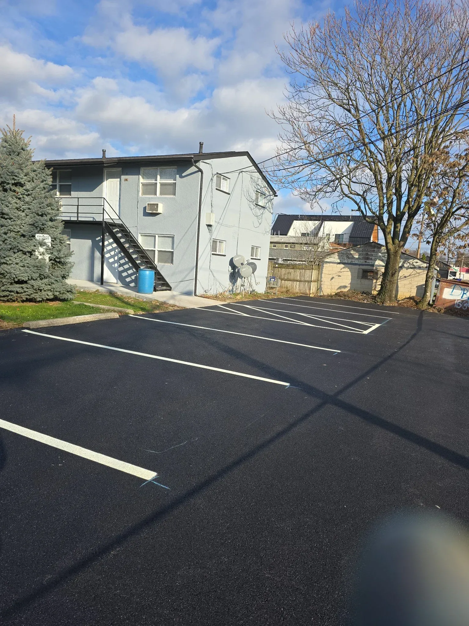 A parking lot with a building in the background