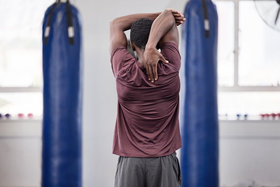 Man doing a shoulder stretch. 
