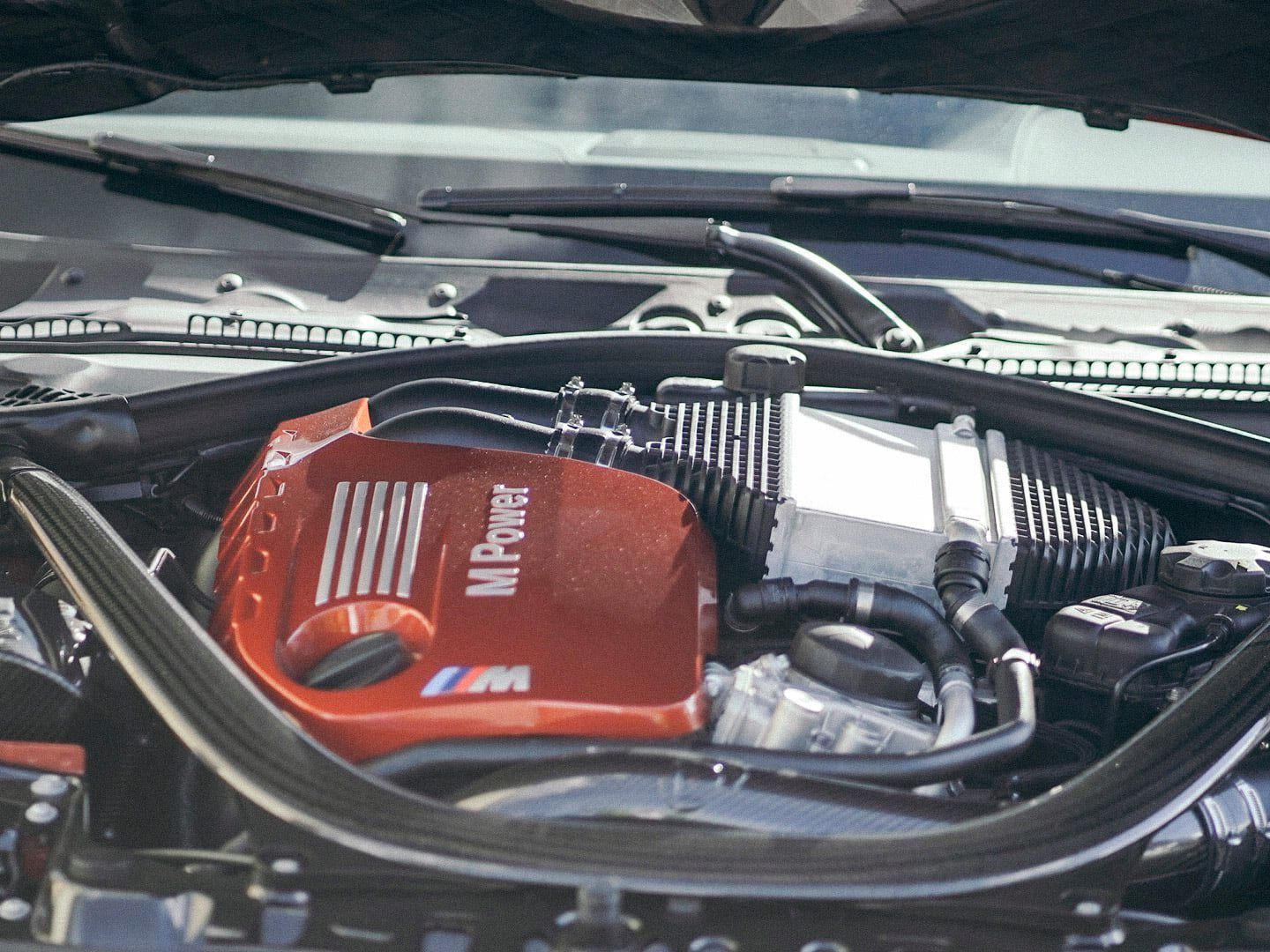 A close up of a car engine that says ' m power ' on it