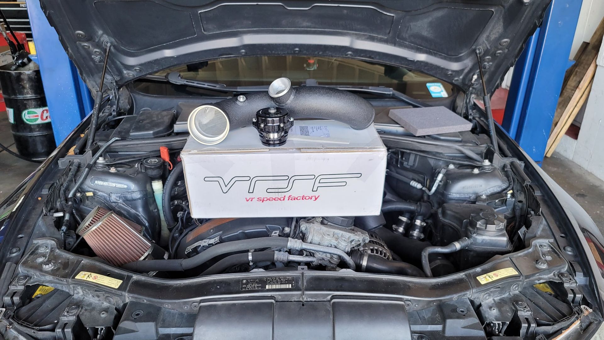 The hood of a car is open and the engine is visible.