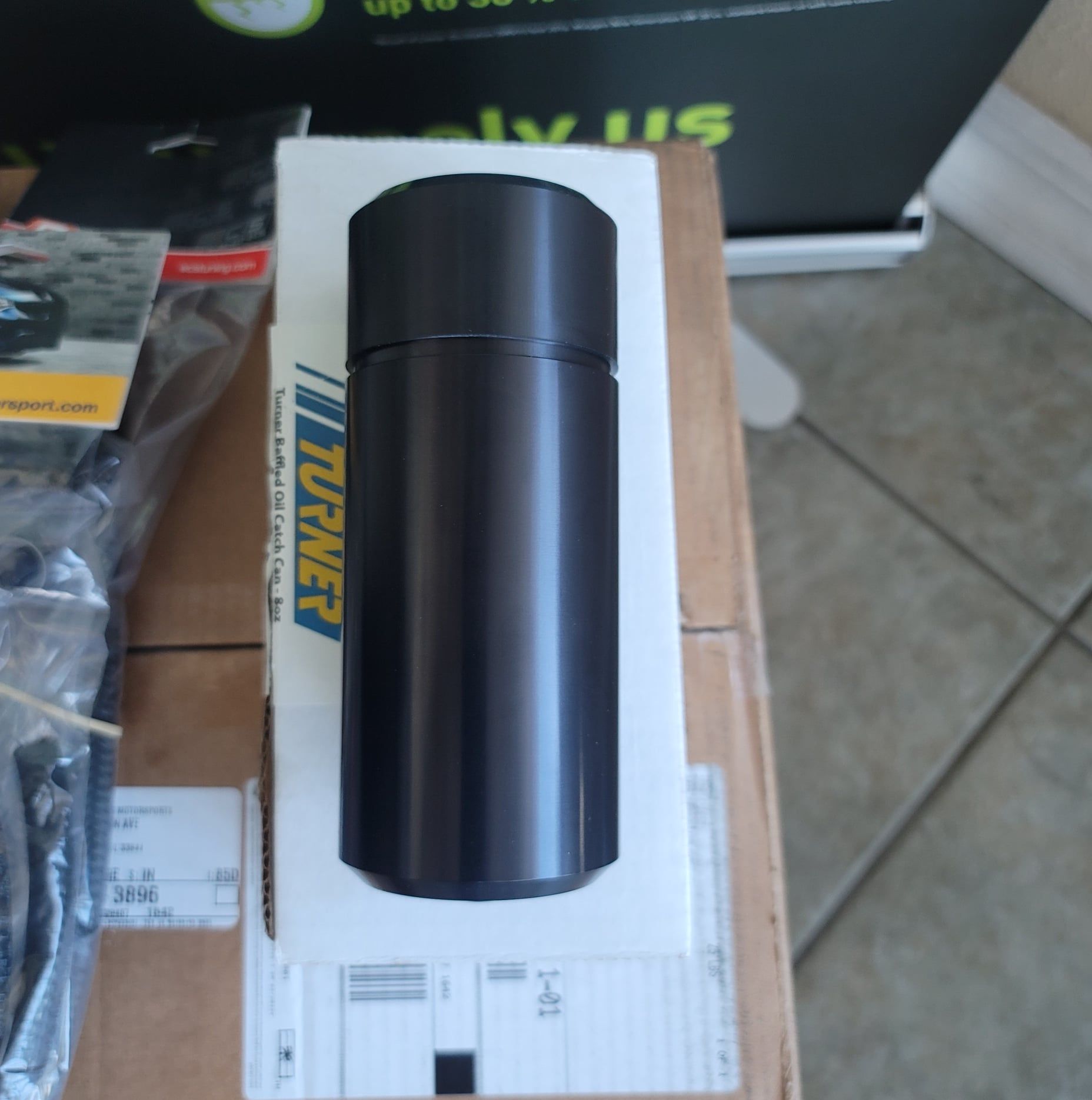 A black thermos in a box that says turner