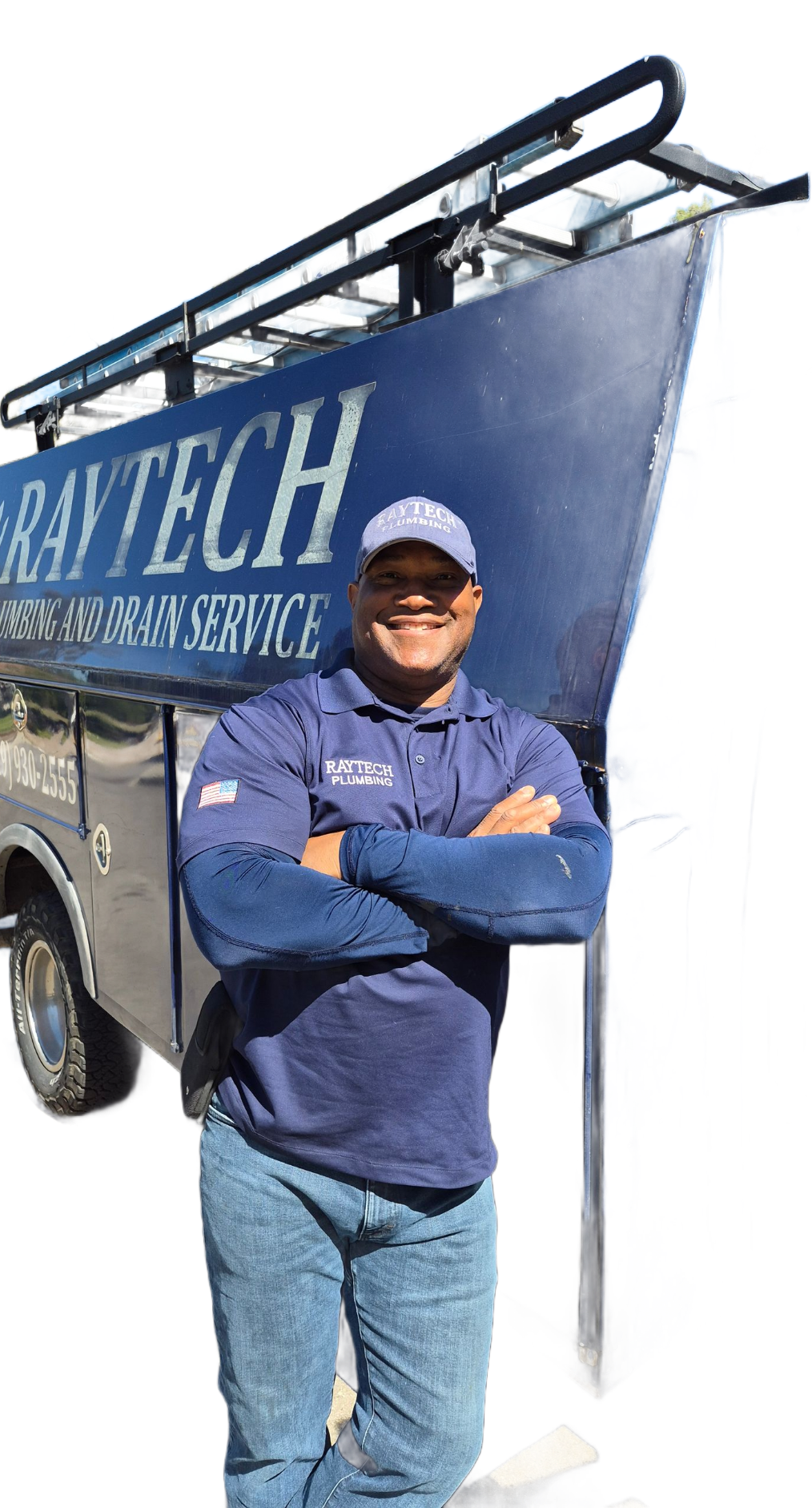 Man in blue shirt, arms crossed, standing in front of a blue van with 