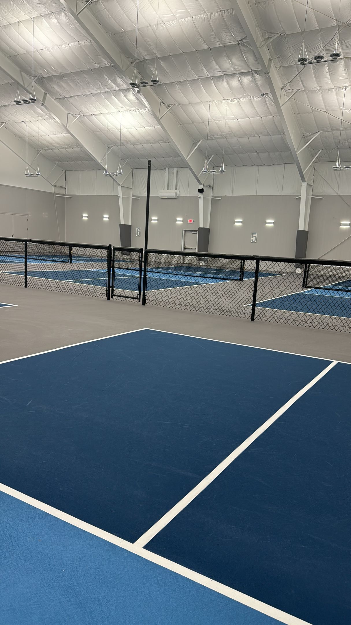 There is a tennis court in the middle of the room.
