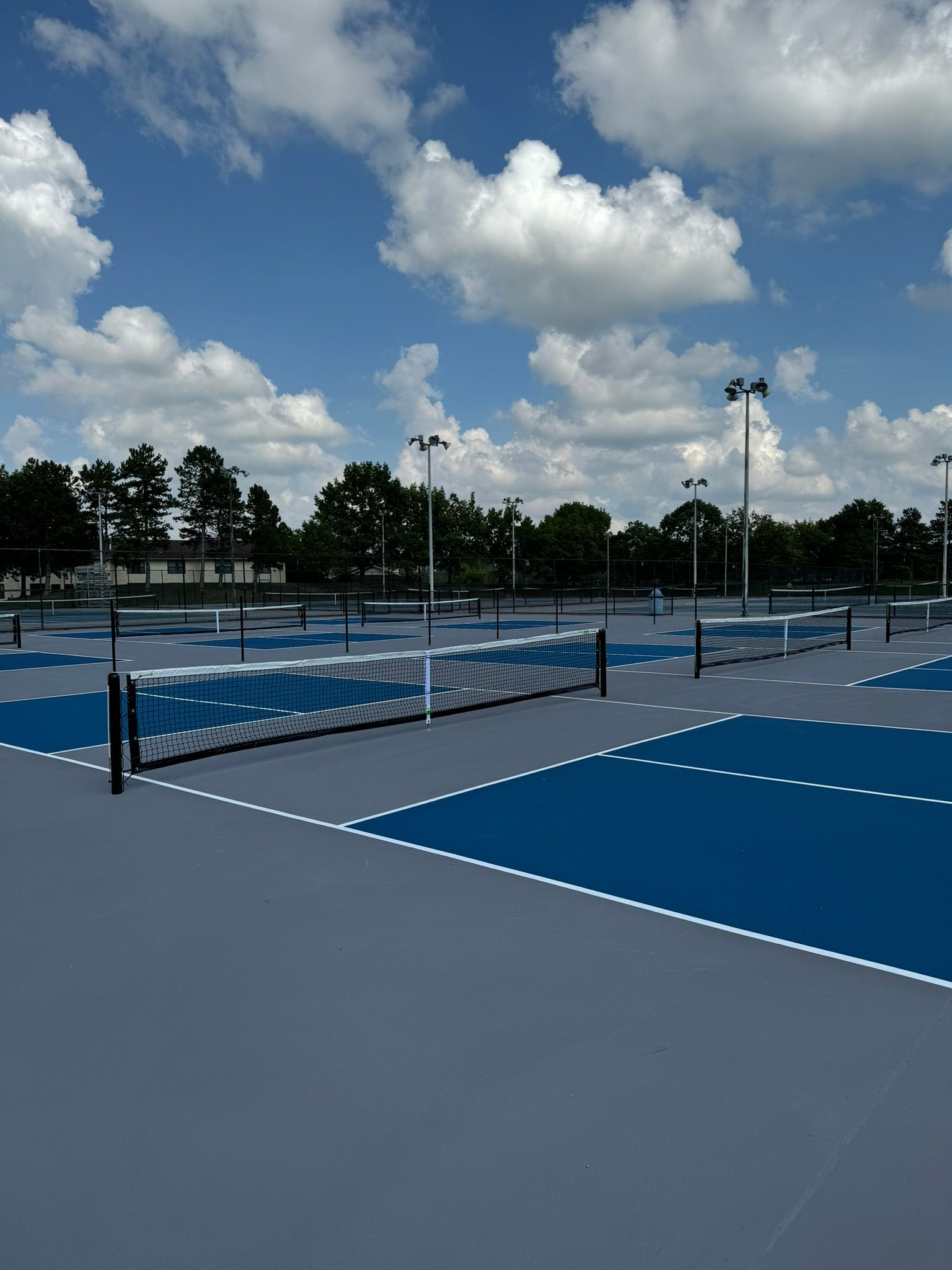 A tennis court with a blue court and a white net