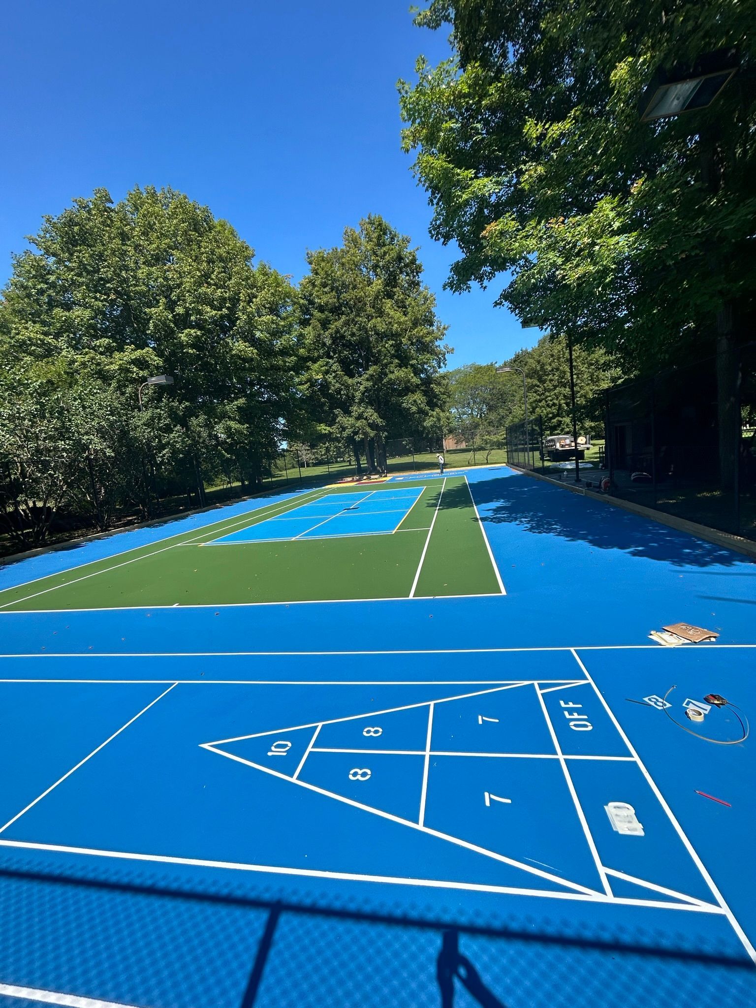 A blue tennis court with a triangle on it