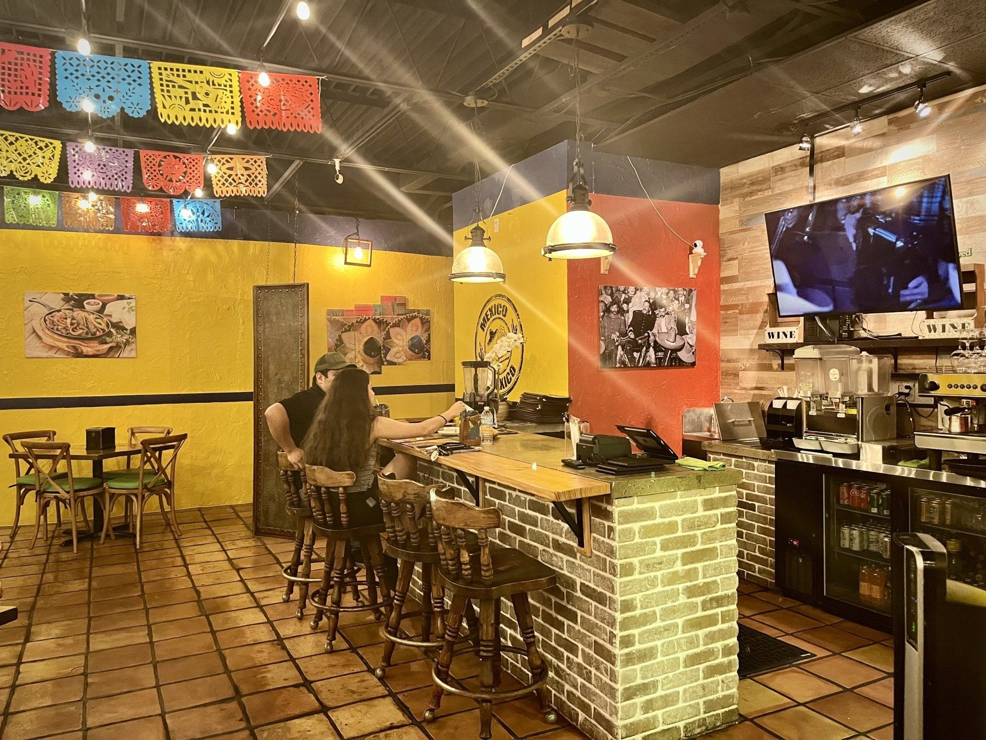 A group of people are sitting at tables in a restaurant.