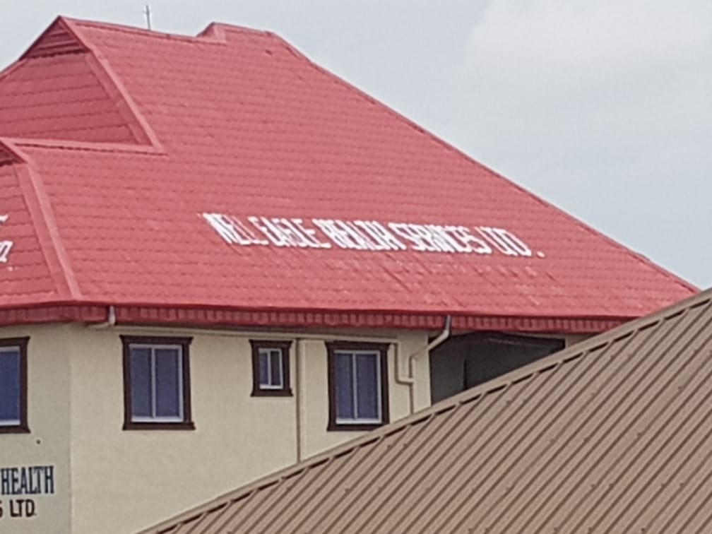 A building with a red roof and a sign that says health