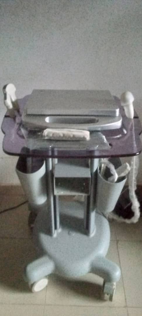 A laptop computer is sitting on top of a glass table.