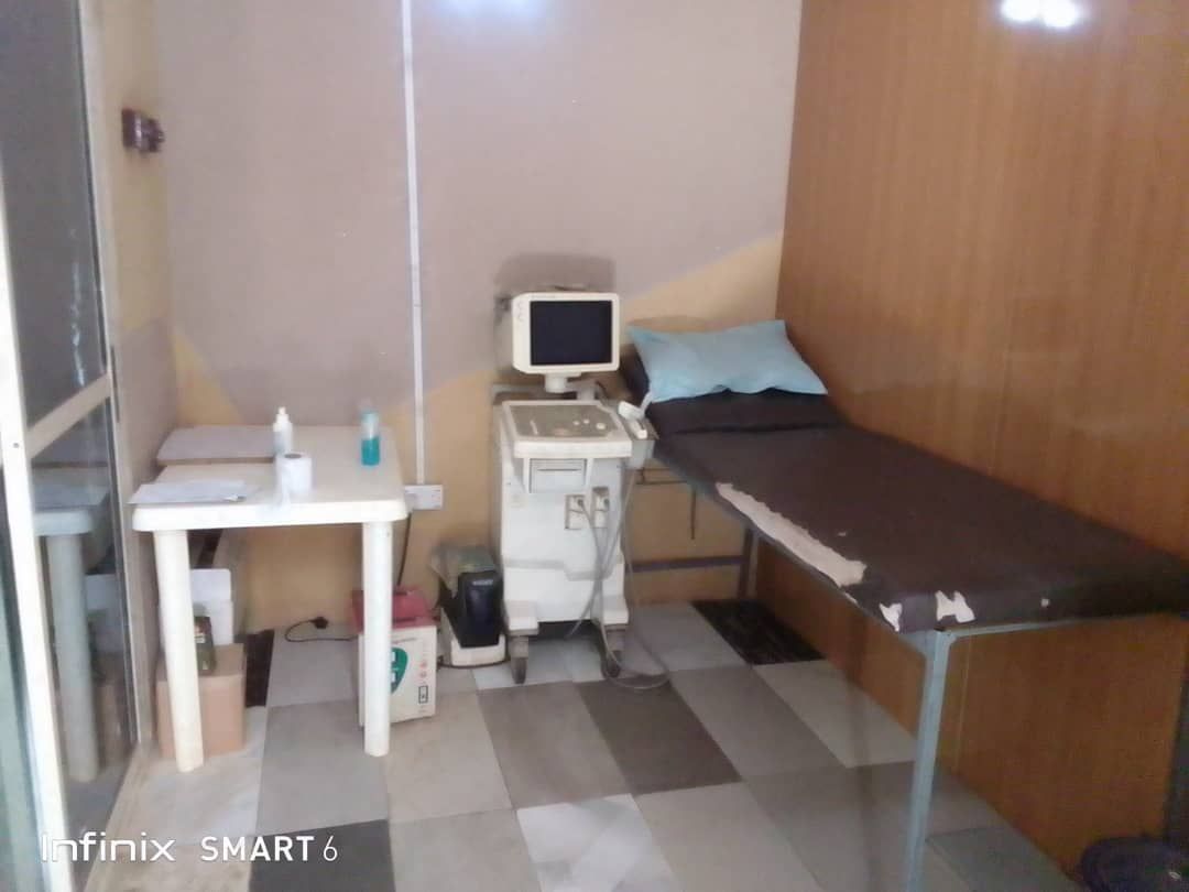 A room with a bed and an ultrasound machine