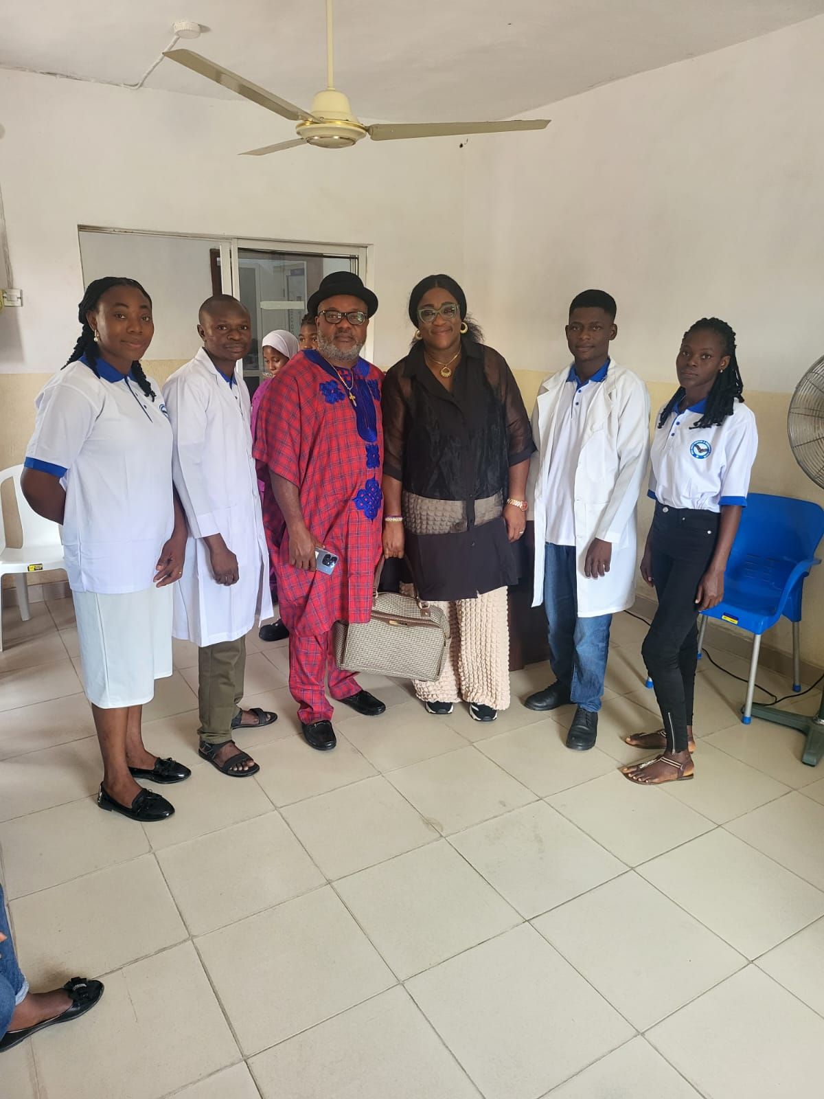 A group of people standing next to each other in a room.