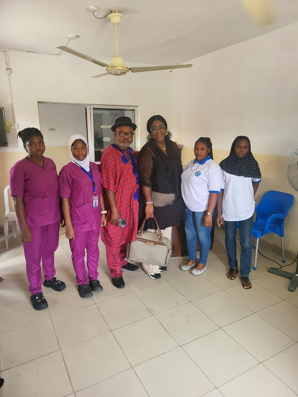 A group of people are posing for a picture in a room.