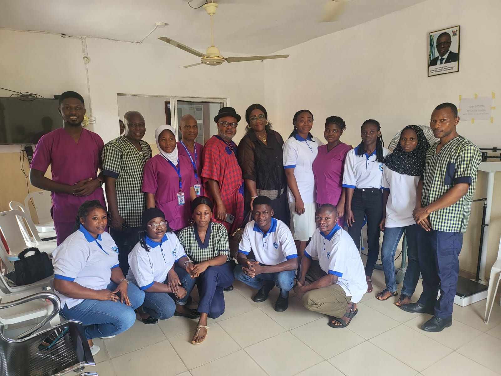 A group of people are posing for a picture in a room.