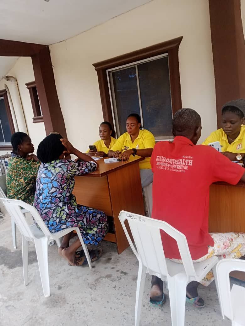 A group of people are sitting around a table having a meeting.