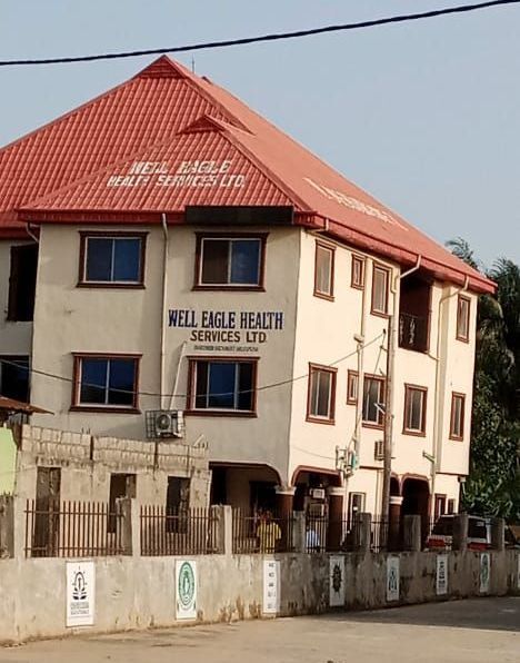 A well eagle beach services ltd building with a red roof