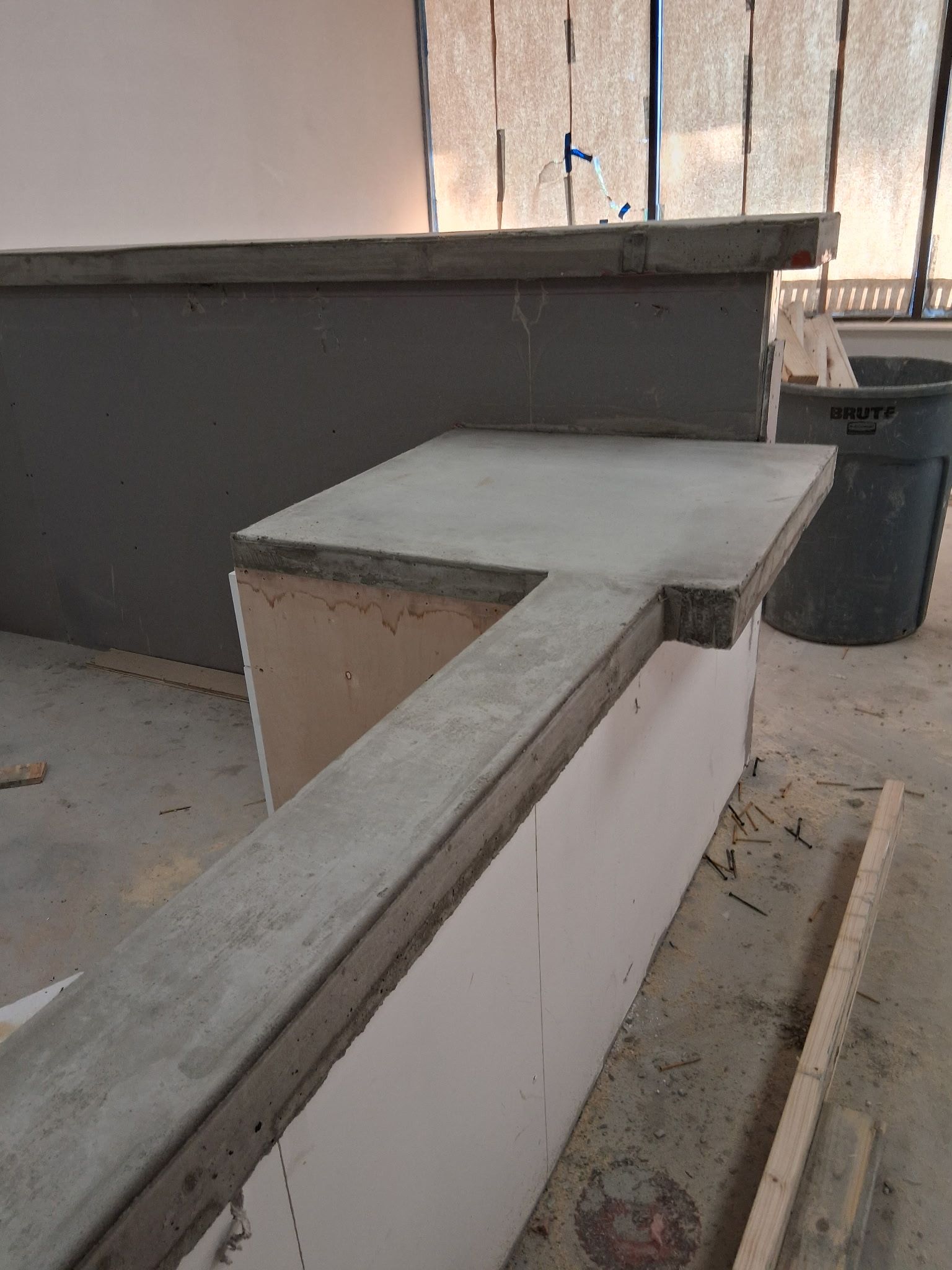 Concrete countertop under construction with grey and white surfaces.