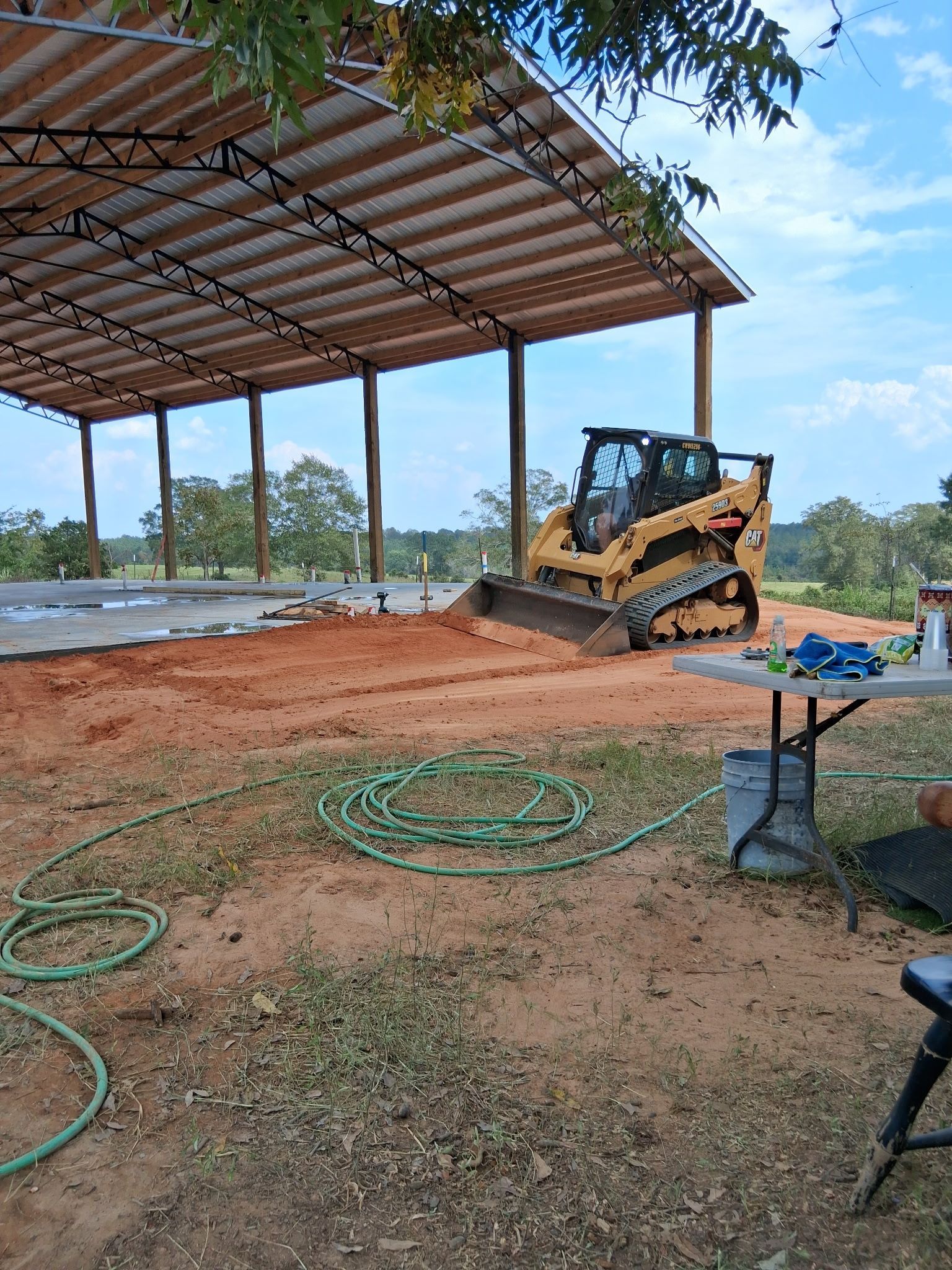 A concrete floor in a garage with a wooden wall.