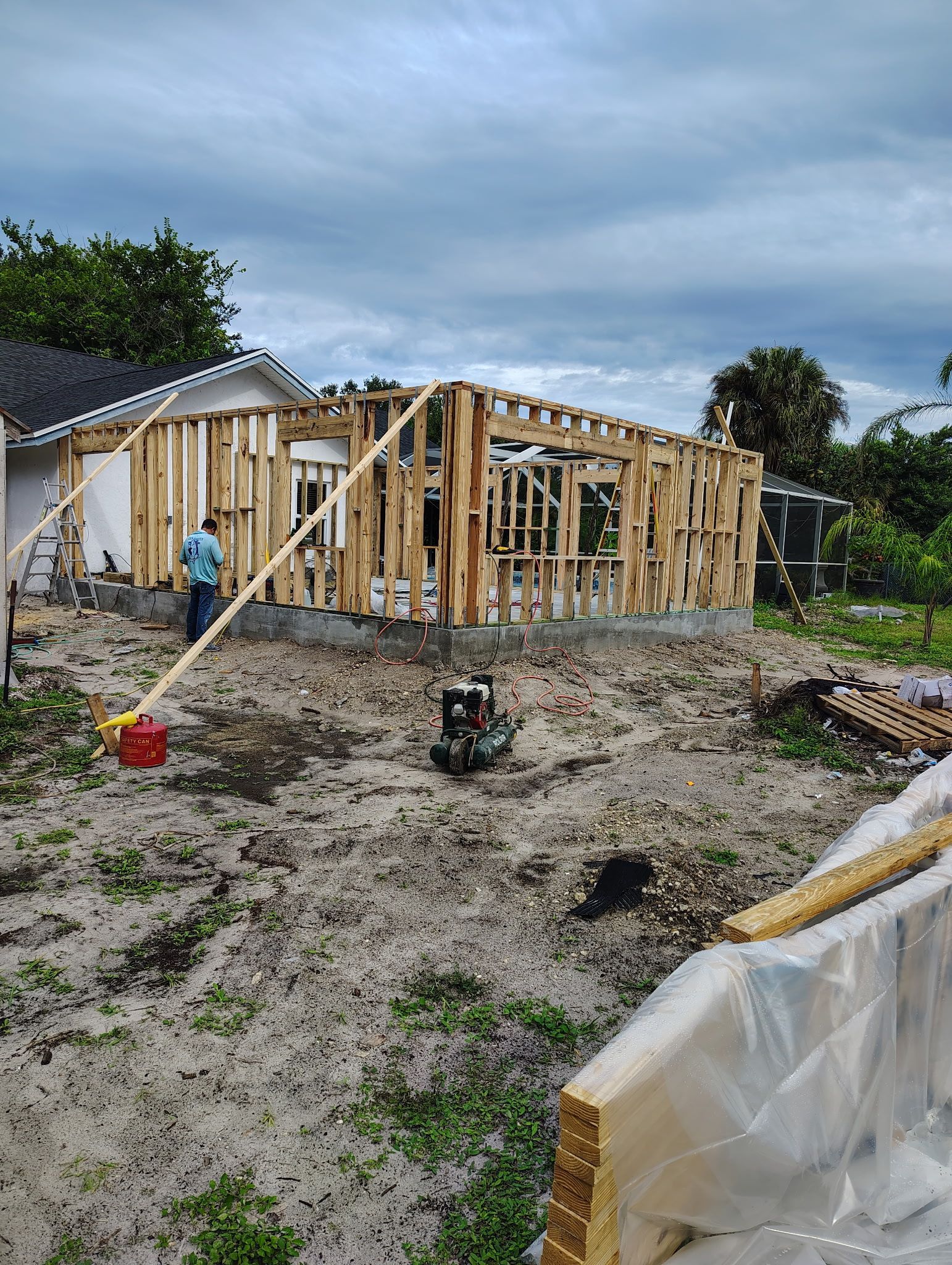 A group of construction workers are working on a concrete driveway.
