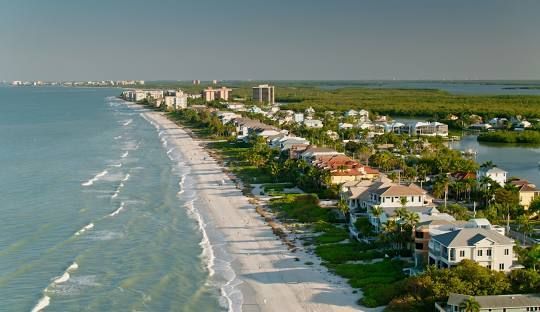 A museum building with a log cabin in front of it.