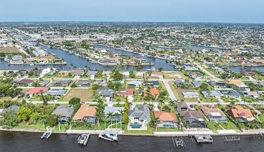 An aerial view of a residential neighborhood with mountains in the background.