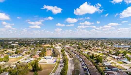 An aerial view of a residential neighborhood with mountains in the background.