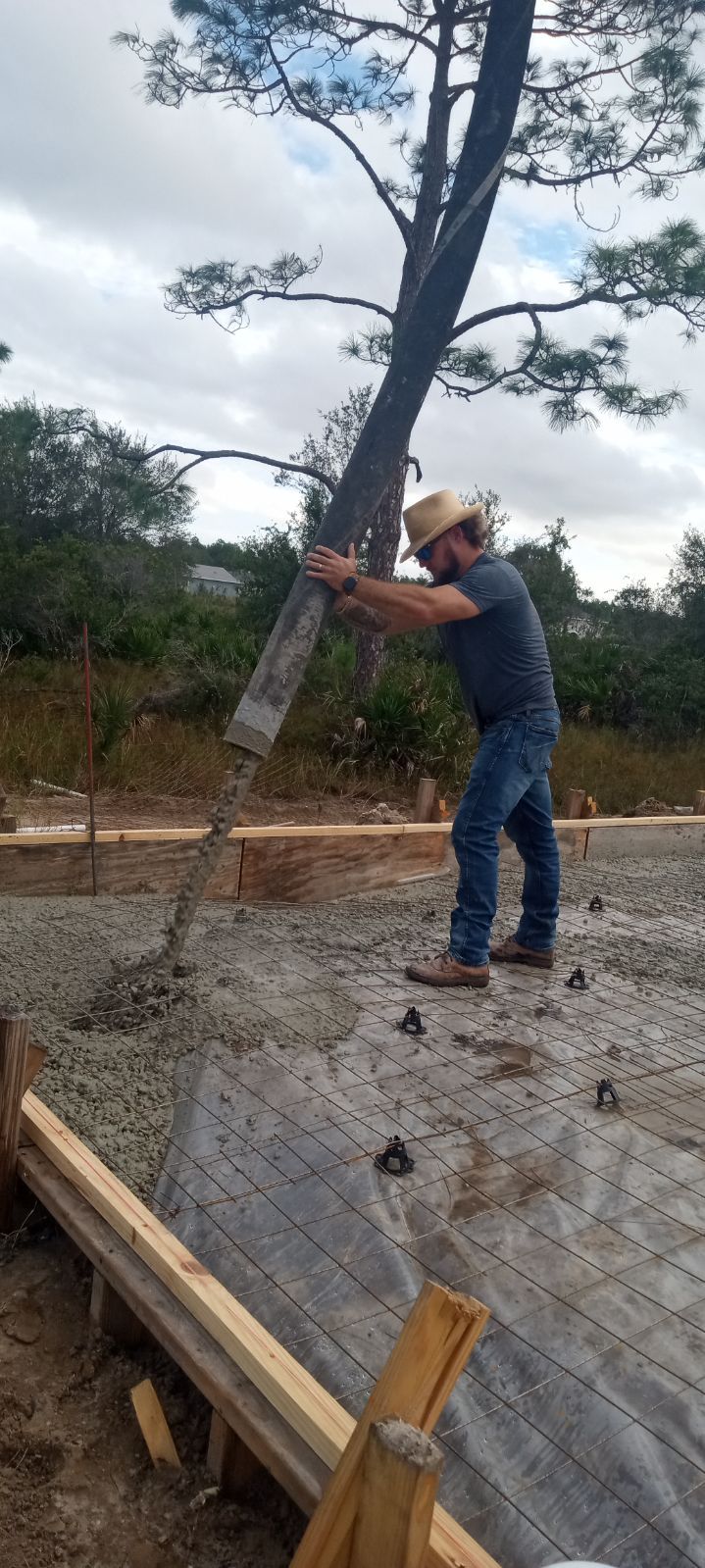 A concrete floor in a garage with a wooden wall.
