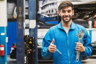 Mechanic Holding Wrench — Dundee, IL — Dundee Collision Inc.