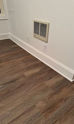 Overhead view of a house with a gray roof, a pool, and green lawn.