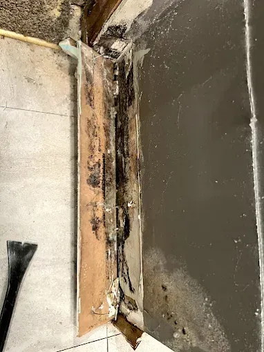 Aerial view of a house with a gold metal roof, pool, and parked truck in the yard.