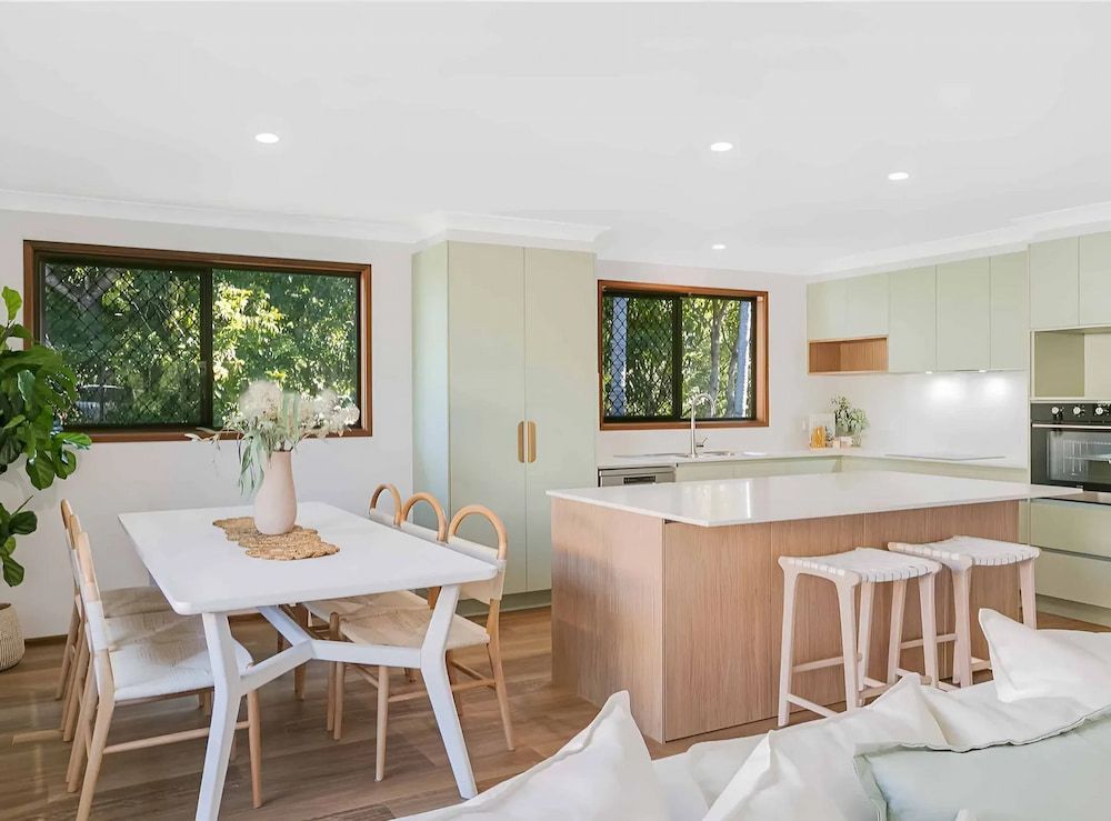 A Living Room With A Dining Table And Chairs And A Kitchen — D & L Custom Cabinets  In South Murwillumbah, NSW 