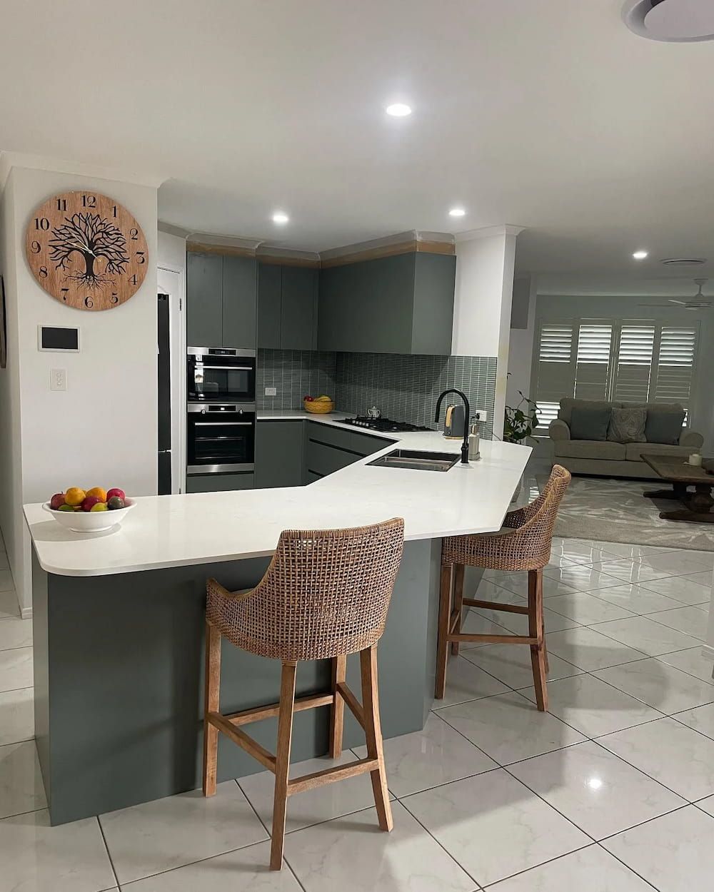 A Kitchen With Two Wicker Chairs And A Clock On The Wall — D & L Custom Cabinets In Byron Bay, NSW
