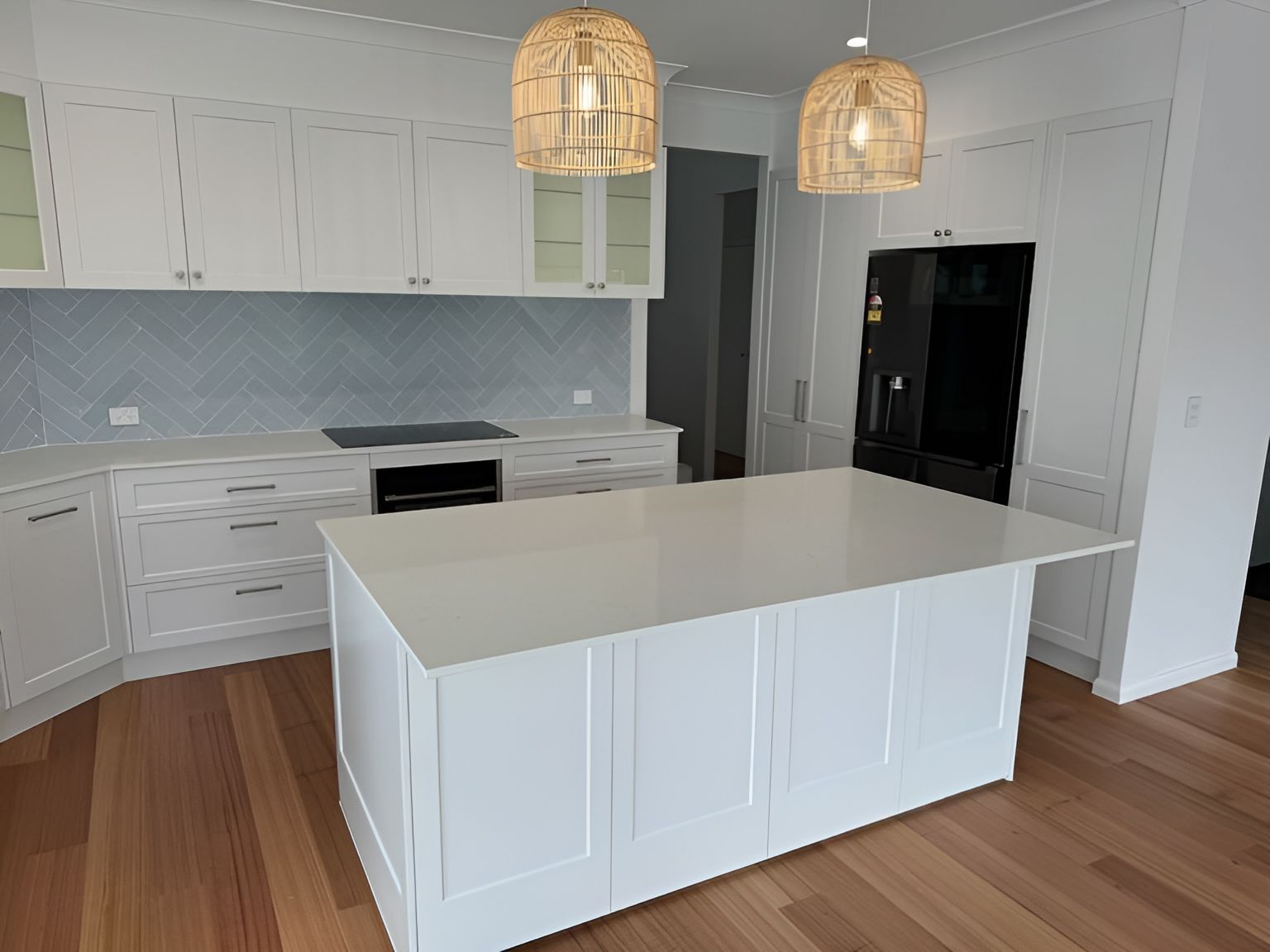 A Kitchen With White Cabinets And A Large Island In The Middle — D & L Custom Cabinets  In South Murwillumbah, NSW 