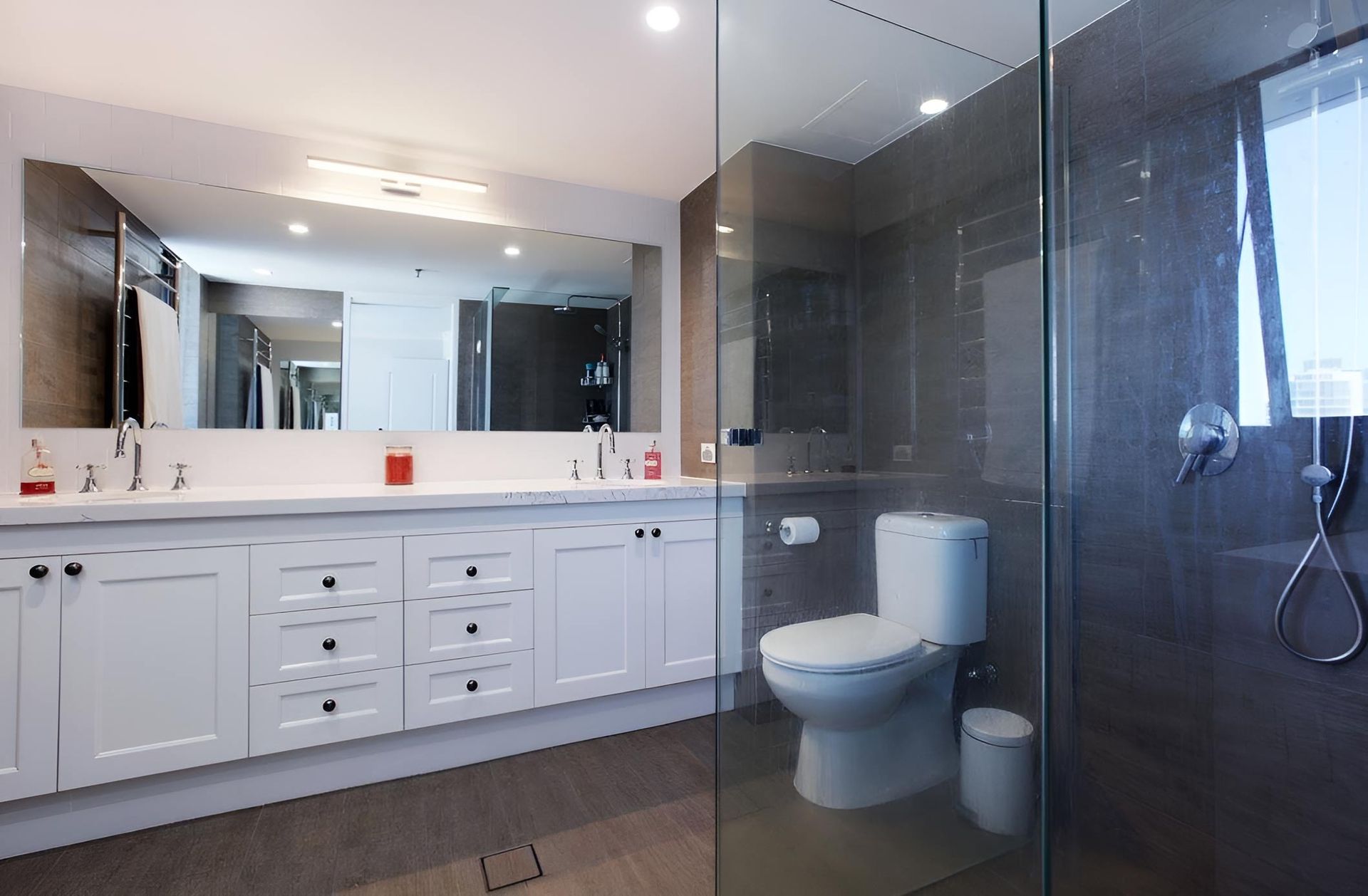 A Bathroom With A Toilet , Sink , Mirror And Walk In Shower — D & L Custom Cabinets In South Murwillumbah, NSW