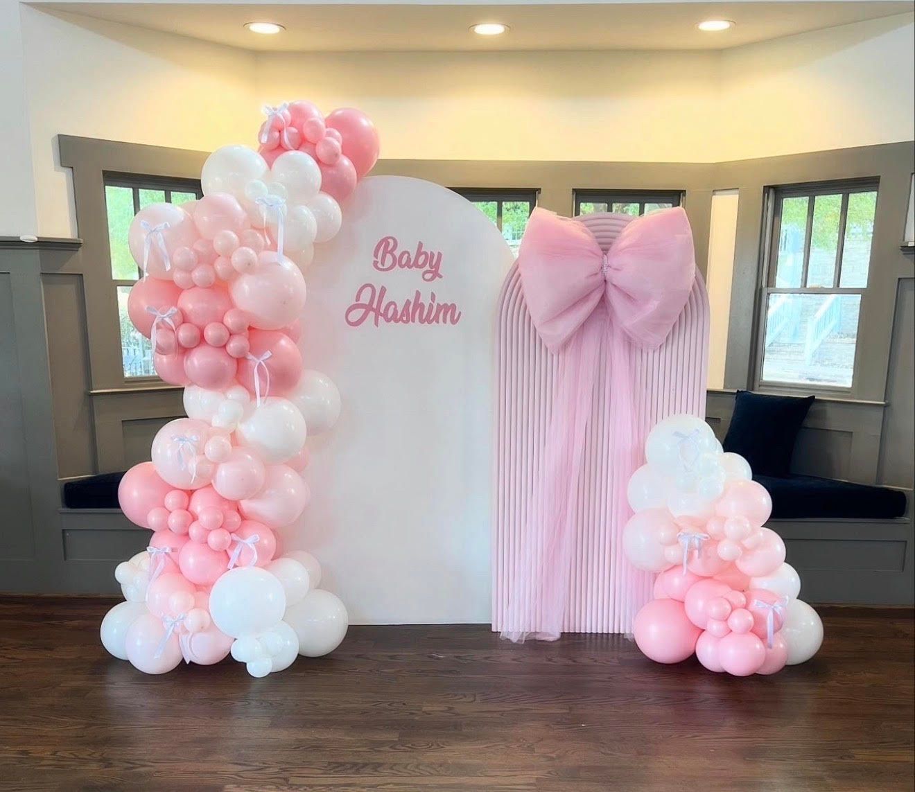 Pink and white balloon arch with 