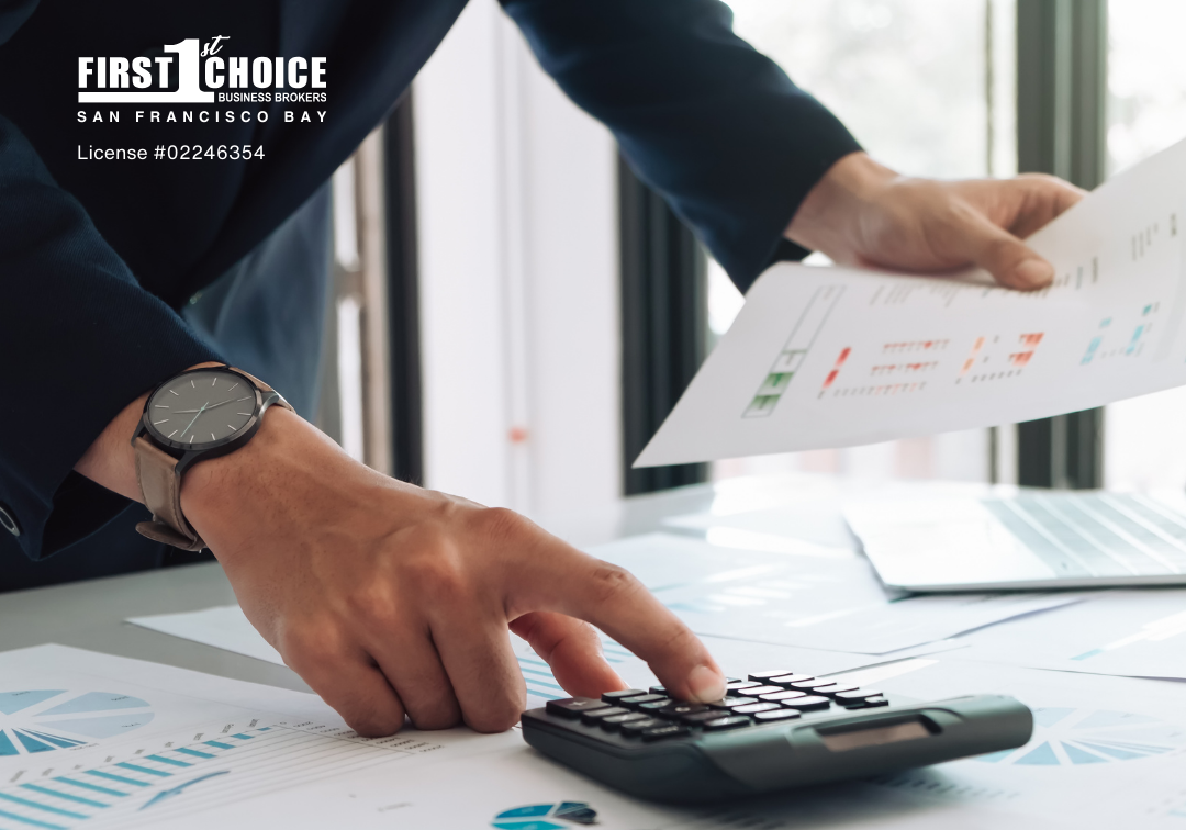 A man is using a calculator while holding a piece of paper.