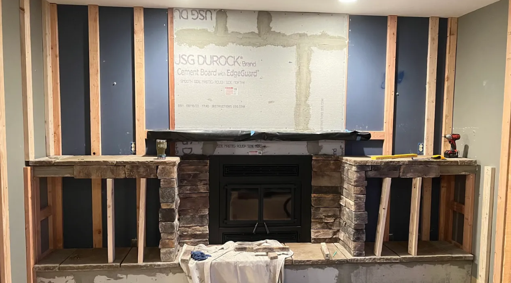 A fireplace is being built in a basement.