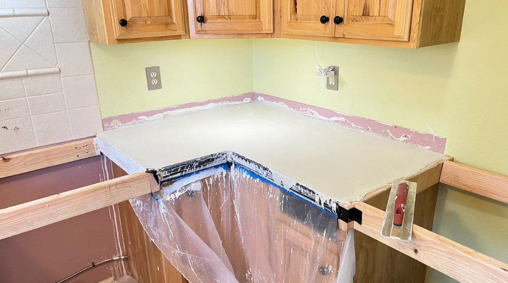 A kitchen counter is being painted in a house.