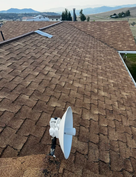 A satellite dish on the roof of a house