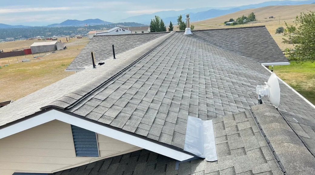 A roof of a house with a view of a mountain.
