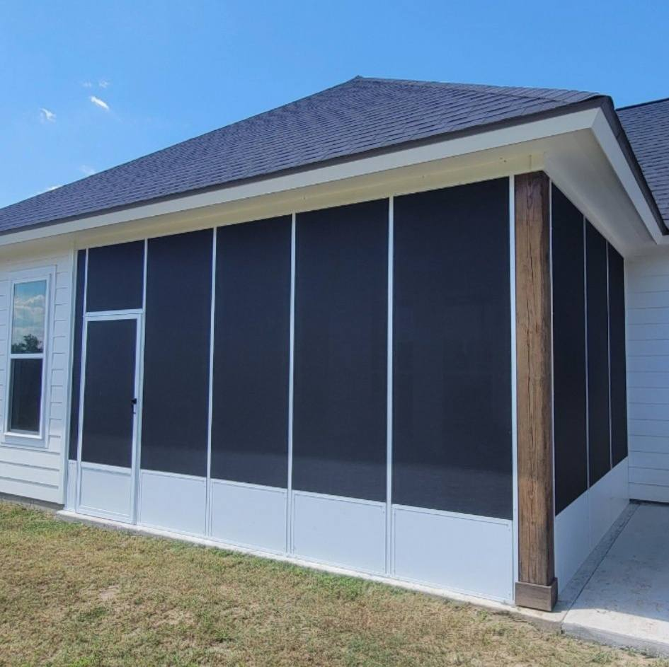 Screened-in patio with white and black panels, a door, and a brown wooden beam. Bright, sunny day.