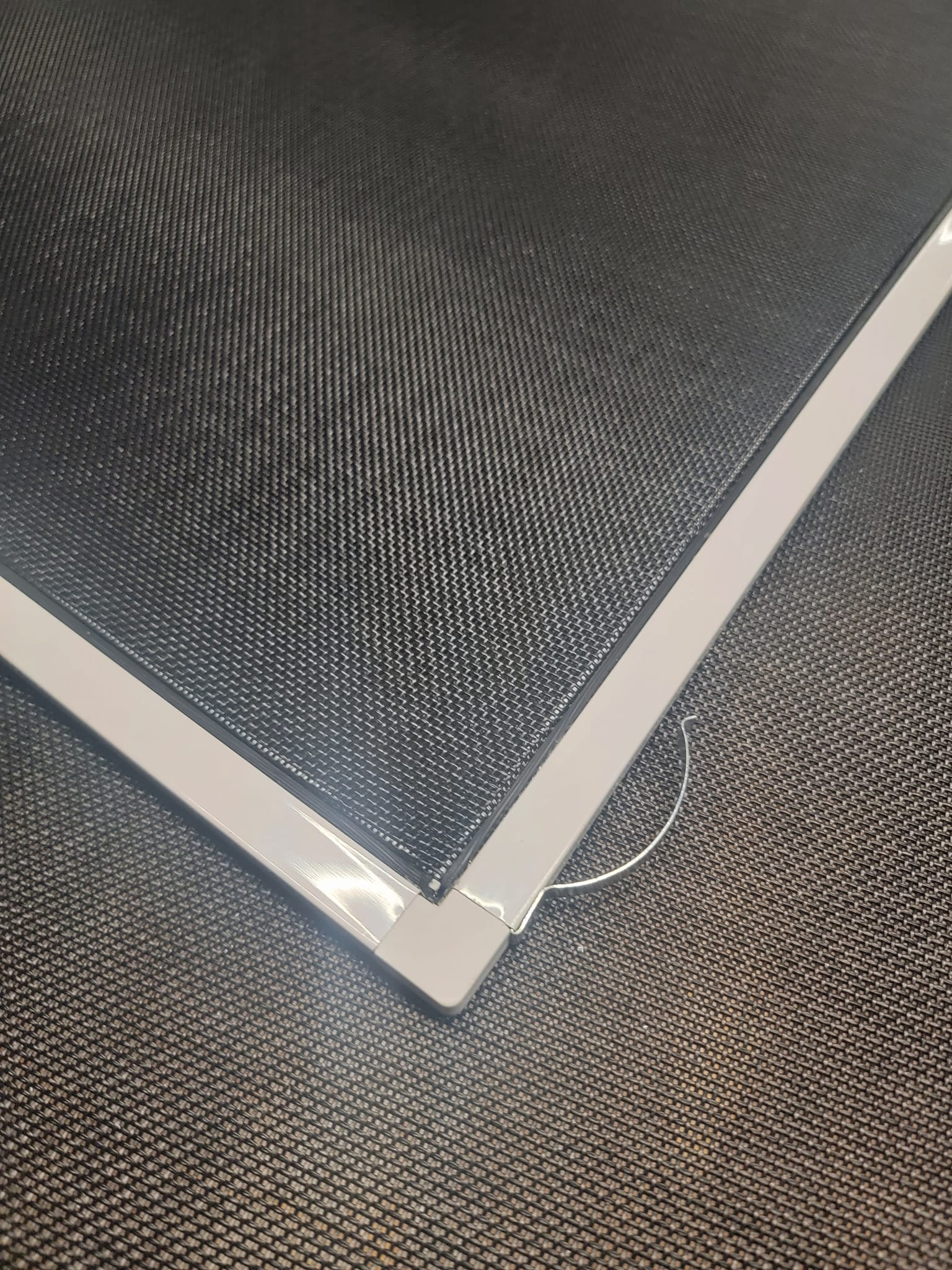 Close-up of a black screen with white trim forming a corner.