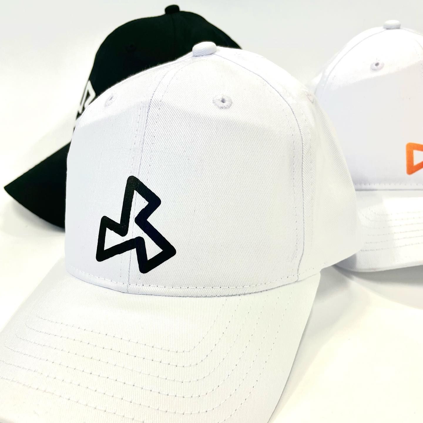 A white baseball cap with a black triangle on it
