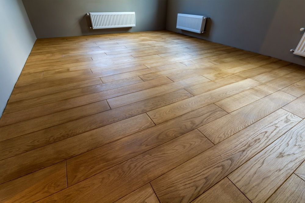 A Room With a Wooden Floor and Two Radiators — Freedom Flooring Pty Ltd in Adamstown, NSW