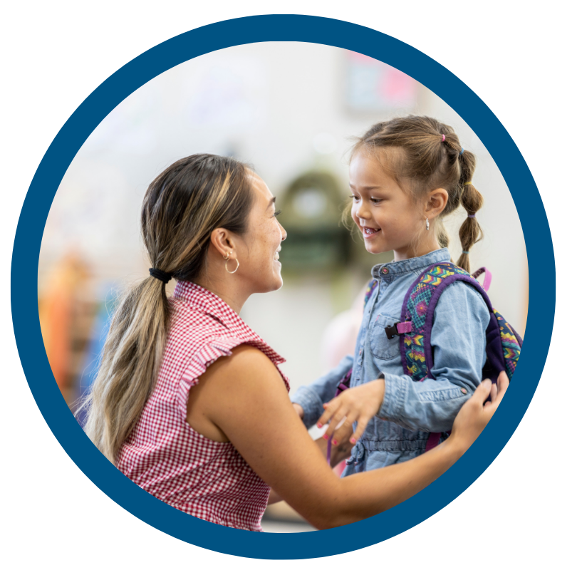 A woman is holding a little girl in her arms in a circle.