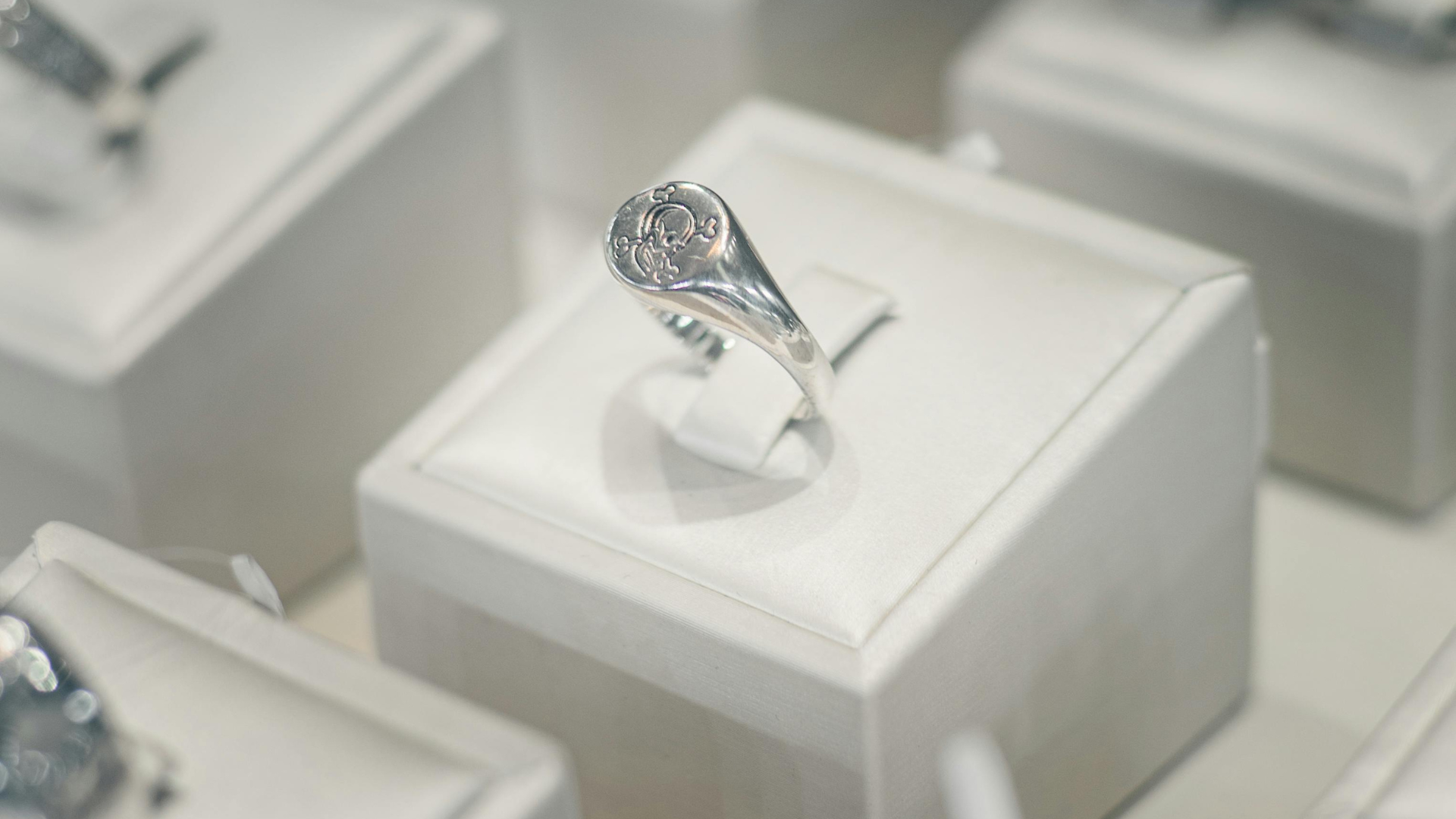 Hand placing a family icon block on a stack of blocks representing insurance needs: health, home, car, finances, travel.