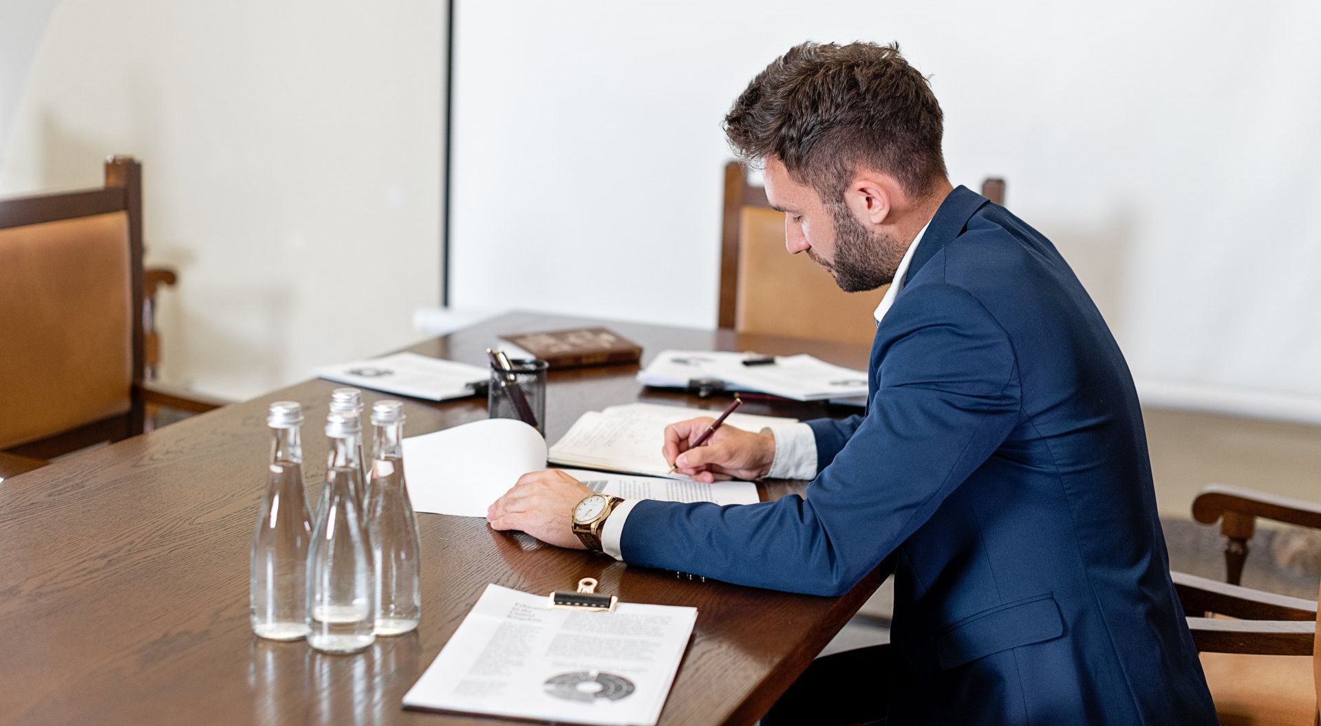 man in suite at a desk