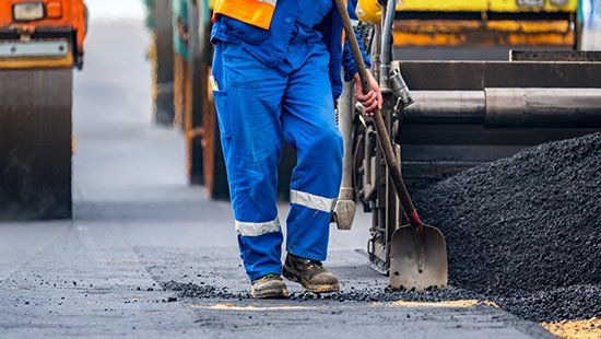 The workers and the asphalting machines — Hudson, NC — Asphalt Roads The workers and the asphalting machines — Hudson, NC — Asphalt Roads