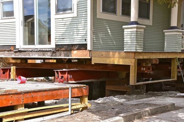 a house being built with a wooden deck
