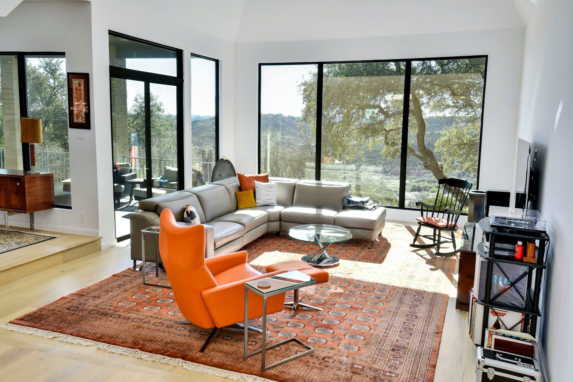 An empty living room with hardwood floors and a fireplace.